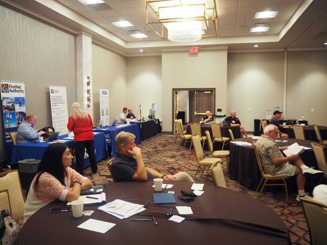 Attendees and exhibitors interacting in breakout session room | NAEFO Conference